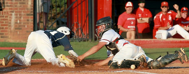 South Point catcher Tim Davila drops the ball as he tags Aly Dawood at the plate during their 11-5 loss to Cuthbertson Tuesday night in Belmont. [JOHN CLARK/THE GASTON GAZETTE]