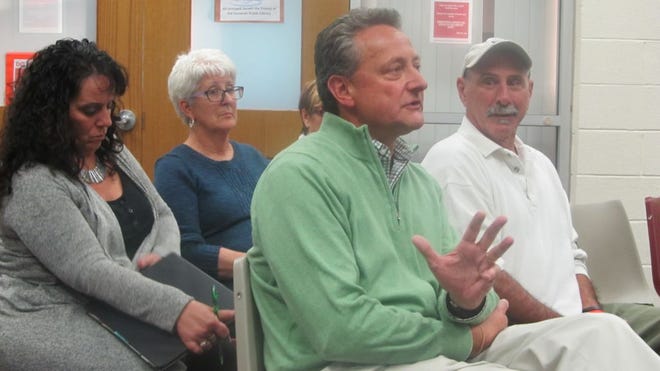 Marc Landry, principal of High Road Hospitality, greets selectmen and public at a recent meeting after his bid for 14 acres of Route 6 town-owned land was accepted. Ken Pereira, one of several Lepes Road residents concerned about commercial expansion, is seated next to Landry and behind him are Town Clerk Dolores Berge, left, and Nancy Fornier, administrative assistant to the town administrator.