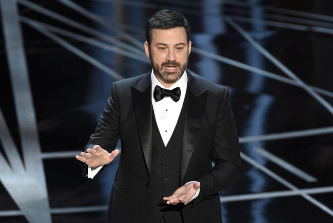FILE - In this Feb. 26, 2017 file photo, host Jimmy Kimmel appears at the Oscars in Los Angeles. The Academy of Motion Picture Arts and Sciences on Tuesday, May 16, 2017, said Kimmel will return for the 90th Oscars on March 4, 2018. THE ASSOCIATED PRESS