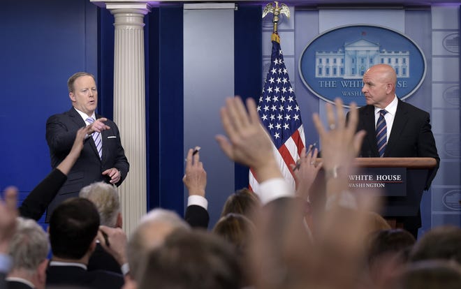 White House press secretary Sean Spicer, left, calls on a reporter as National Security Adviser H.R. McMaster listens at right during a briefing at the White House in Washington, Tuesday, May 16, 2017. President Donald Trump claimed the authority to share "facts pertaining to terrorism" and airline safety with Russia, saying in a pair of tweets he has "an absolute right" as president to do so. THE ASSOCIATED PRESS