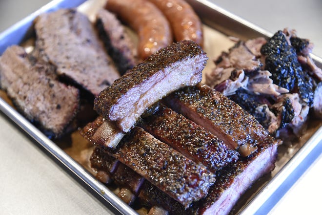 A meat platter at Brick’s Smoked Meats includes St. Louis Ribs, USDA Prime Brisket, Jalapeno Cheddar Sausage and pulled pork. [Herald-Tribune staff photo / Thomas Bender]