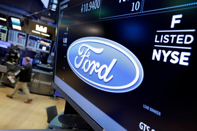 FILE - In this May 16, 2017 file photo, the logo for the Ford Motor Company appears above a post on the floor of the New York Stock Exchange. Ford Motor Co. said Wednesday, May 17, it plans to cut 10 percent of its salaried jobs in North America and Asia Pacific this year in an effort to boost profits.(AP Photo/Richard Drew)
