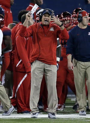 Arizona coach Rich Rodriguez reacts after a penalty during the second half of a game against Arizona State on Nov. 25, 2016, in Tucson, Ariz. The hot seat in college football can be defined as a coach who is danger of being fired if his team does not improve upon last season. [AP Photo / Rick Scuteri, File]