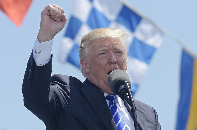 President Donald Trump gestures as he gives the commencement address at the U.S. Coast Guard Academy in New London, Conn., Wednesday. [SUSAN WALSH/AP]