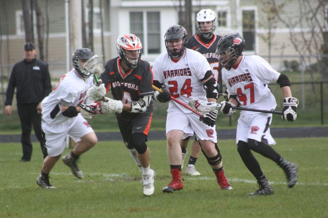 Wells teammates Riley Dempsey, left, Travis Kay (24) and Ben Thurber (47) battle for a loose ball with Biddeford's Mitchell Farley (4) during the first half of Monday's boys lacrosse game at Forbes Field.

[Carl Pepin/Seacoastonline]