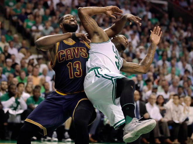 Cleveland's Tristan Thompson (13) and Boston's Marcus Smart tangle during the third quarter.