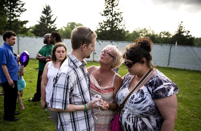 Diane Folder, center, is comforted by Issac Brello and Tiffany Ridge during the celebration of the life of Folder's daughter, Sammi Cody-Neuhoff, at the Chatham VFW Wednesday, May 16, 2017. Cody-Neuhoff died Friday as a result of her heroin addiction, her family said. [Rich Saal/The State Journal-Register]