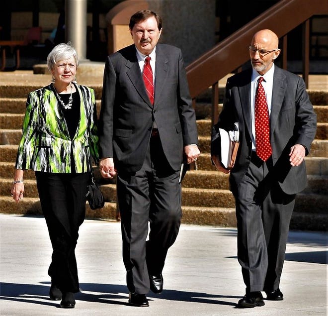 Former North Carolina state Sen. Fletcher Hartsell, flanked by his wife, Tana, and defense attorney Rock Glaser, are shown leaving the federal courthouse on Tuesday, May 16, 2017. Hartsell was sentenced to eight months in prison for misusing more than $200,000 in campaign funds for personal use. (AP Photo/Skip Foreman)