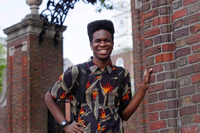 Obasi Shaw poses outside the gates of Harvard Yard in Cambridge, Mass., Thursday, May 18, 2017. Shaw, an English major who graduates from Harvard next week, is the university’s first student to submit his final thesis in the form of a rap album. The record, called “Liminal Minds,” has earned the equivalent of an A- grade, good enough to ensure that Shaw will graduate with honors at the university’s commencement next week. (AP Photo/Charles Krupa)