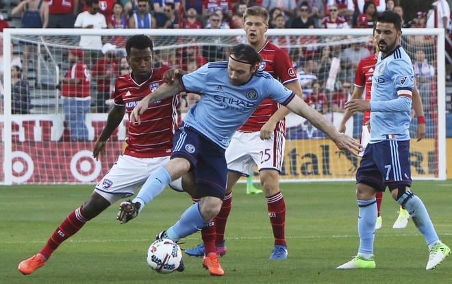 FC Dallas midfielder Kellyn Acosta, left, wrestles with New York City FC midfielder Thomas McNamara (15) for the ball during the first half of an MLS soccer game in Frisco, Texas, on Sunday. [Steve Hamm / The Dallas Morning News via AP]