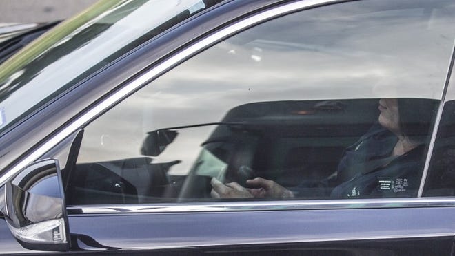 House Bill 62 would create a statewide ban on texting while driving. Here a woman is shown using her cell phone while driving last September on Interstate 35 in Austin, where police ticketed her for violating the city’s hands-free ordinance. Ricardo B. Brazziell / AMERICAN-STATESMAN