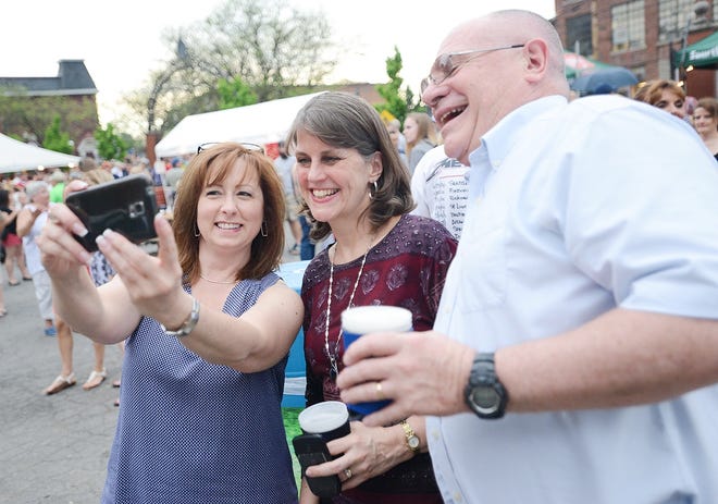 From left, Ilion resident Leshia Kozenewski takes a selfie with Deerfield residents Sheila and Dick Bishop during the opening night of Saranac Thursdays on May 18 in Utica. [ALEX COOPER/OBSERVER-DISPATCH]