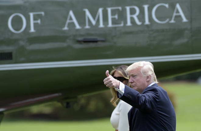 President Donald Trump, accompanied by first lady Melania Trump, gives a thumbs-up as they walk across the South Lawn of the White House in Washington, Friday, May 19, 2017, to board Marine One for a short trip to Andrews Air Force Base, Md. Trump is leaving for his first foreign trip, visiting Saudi Arabia, Israel, Vatican, and a pair of summits in Brussels and Sicily. THE ASSOCIATED PRESS