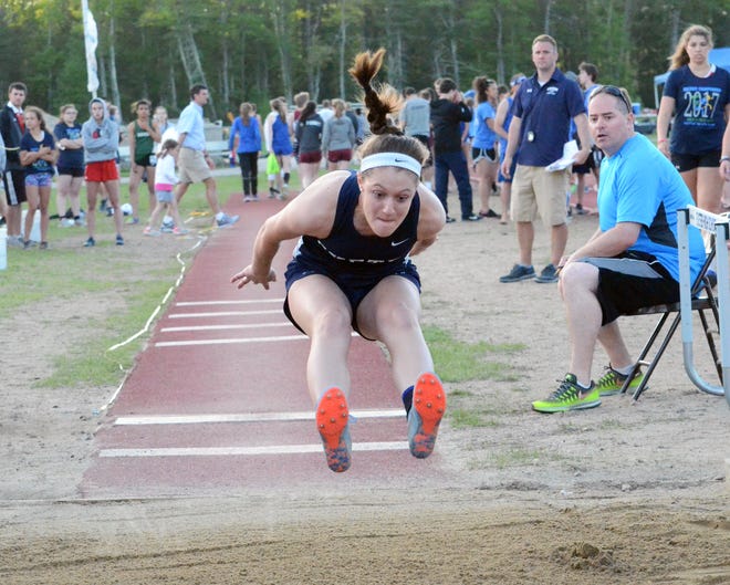 Exeter High Schoolís Kelsey Peirce attempts the girls long jump during Fridayís Seacoast Championships. Peirce scored a win in the triple jump for the Blue Hawks, who won the meet with 103 points.