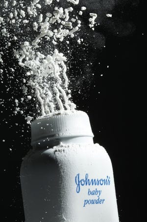 Johnson's baby powder is squeezed from its container. [AP Photo/Matt Rourke, File]
