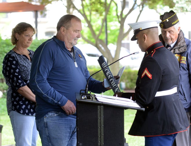 Mark Umbrell receives a banner that featured his son Army 1st Lt. Colby J. Umbrell from USMC PFC Rahul Francis (right) as Nancy Umbrell (left) looks on during a ceremony on Saturday, May 20, 2017, in Doylestown.