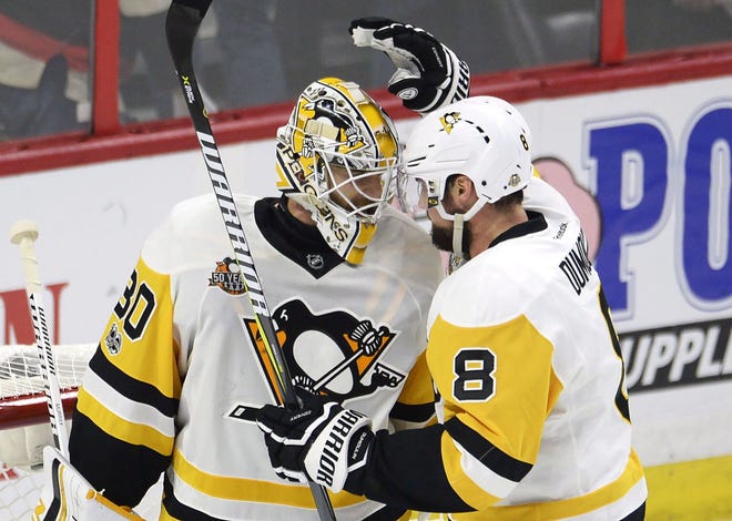 Pittsburgh Penguins goalie Matt Murray (30) and defenceman Brian Dumoulin (8) celebrate after the Penguins defeated the Ottawa Senators 3-2 during Game 4 of the NHL hockey Stanley Cup Eastern Conference finals Friday in Ottawa, Ontario.