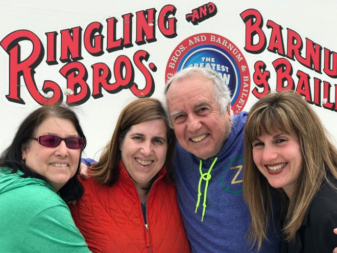 Gene Goldstein, center right, and his family stop for a photo outside the Nassau Veteran's Memorial Coliseum in Uniondale, N.Y., which is hosting the final performances of the Ringling Brothers and Barnum & Bailey Circus, Saturday, May 20, 2017. From left are Cheryl Goldstein, Dawn Mirowitz, Gene Goldstein and Heather Greenberg. (AP Photo/Tamara Lush)