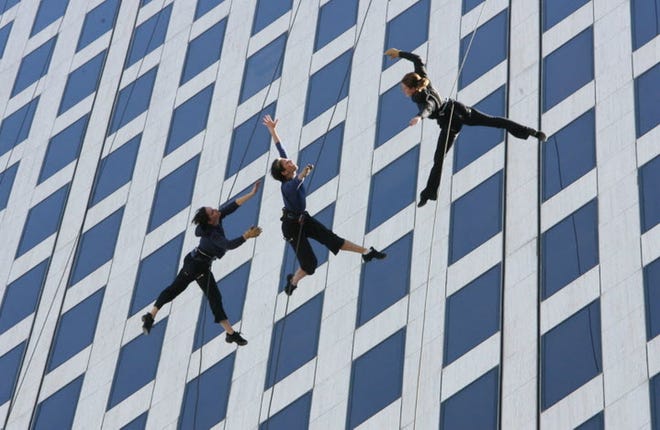 Bandaloop members on the side of One Financial Plaza in downtown Providence in 2012. The vertical dance troupe will headline this summer's PVDFest. [The Providence Journal, file / Frieda Squires]