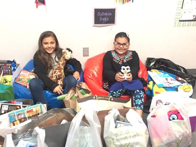 Mesquite Trails Elementary School fourth-graders Giana Anaya and Aislyn Trujillo helped make "blessing bags" to hand out to the less fortunate as part of Passion Week at the school. [Photo courtesy of Marilee Henderson]