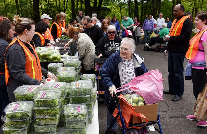 Hundreds of people turn out to fill their bags with fresh produce Friday, May 12, 2017, from Fresh Connect, a pop-up farmers market, at Bucks County Community College in Bristol Township. The year-long market funded by United Way of Bucks County and supported by St. Mary Medical Center, the Bucks County Opportunity Council, Philabundance and Rolling Harvest Food Rescue sets up every Friday in the college's parking lot from noon to 1 p.m. to give out fresh produce to people in need.
