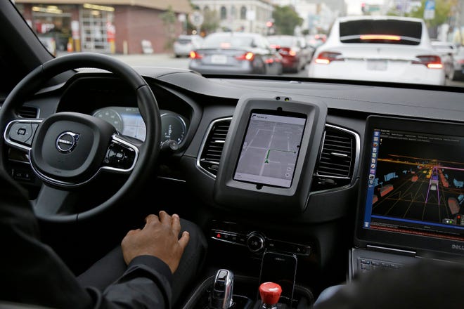 —AP file photo by ERIC RISEBERG

An Uber driverless car waits in traffic during a test drive in San Francisco. Human error and instinct are making it hard for programmers to develop self-driving technology. But experts say eventually the cars will coexist with human drivers on real roads.