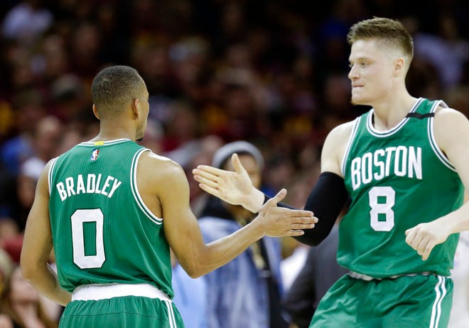 Boston Celtics' Avery Bradley (0) celebrates with Jonas Jerebko (8) after hitting the game winning shot against the Cleveland Cavaliers during the second half of Game 3 of the NBA basketball Eastern Conference finals, Sunday, May 21, 2017, in Cleveland. The Celtics won 111-108. (AP Photo/Tony Dejak)