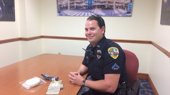 Palm Beach Gardens Police Officers Daniel Abraira (pictured) and Abe Tawil helped save a man with a severe cut from bleeding out before fire medics could arrive at Legacy Place, where he had lost a lot of blood in one of the residences. The officers had just taken a class with the city’s SWAT medics about hemorrhage control and tourniquet application a few months prior. A tourniquet, Israeli bandage and face mask are on the table in front of Abraira.