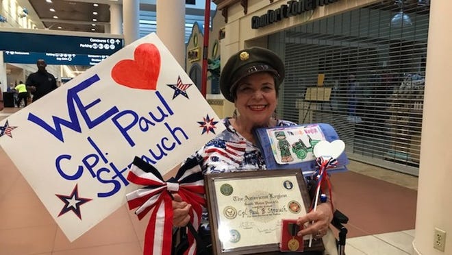 Mary Strauch awaits the return of her husband, Korean War veteran Paul Strauch, at Palm Beach International Airport. (Photo by Conner Mitchell)