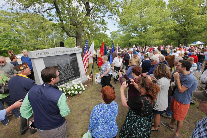 People gather for a closer look at the monument honoring Pawtucket's servicemen who died during the Vietnam War. [The Providence Journal / Glenn Osmundson]