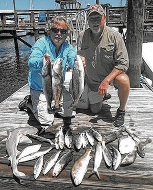 Daryl Gay, left, and Capt. David Newlin with the trout, redfish, flounder, whiting and a bonnet head shark they caught May 15. (Courtesy of David Newlin)