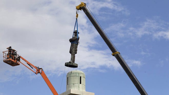A statue of Confederate General Robert E. Lee is removed from Lee Circle on Friday in New Orleans. (Associated Press)