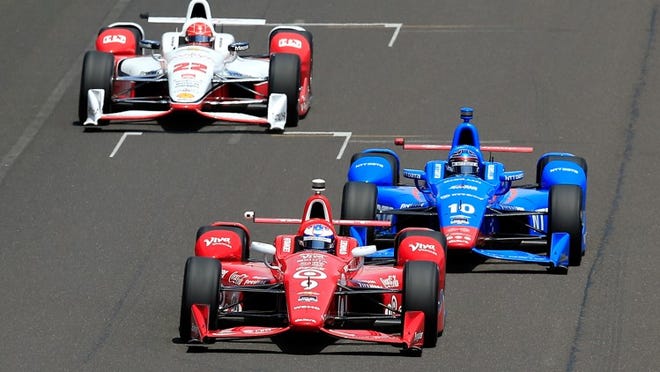 INDIANAPOLIS, IN - MAY 23: Scott Dixon, driver of the #9 Target Chip Ganassi Racing Chevrolet Dallara, races ahead of Tony Kanaan, driver of the #10 Chip Ganassi Racing Chrolet Dallara, and Simon Pagenaud, driver of the #22 Team Penske Chevrolet Dallara, during the 99th running of the Indianapolis 500 at Indianapolis Motorspeedway on May 23, 2015 in Indianapolis, Indiana. (Photo by Jamie Squire/Getty Images)