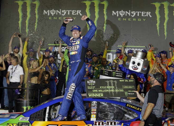 Kyle Busch celebrates in Victory Lane after winning the NASCAR All-Star race Saturday night at Charlotte Motor Speedway. [CHUCK BURTON/THE ASSOCIATED PRESS]