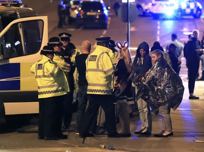Emergency services personnel speak to people outside Manchester Arena after reports of an explosion at the venue during an Ariana Grande concert in Manchester, England, Monday, May 22, 2017. Nineteen people have died following an explosion Monday night at an Ariana Grande concert in northern England, police and witnesses said. The singer was not injured, according to a representative. THE ASSOCIATED PRESS
