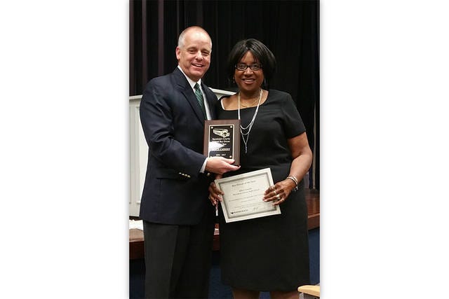 LEADERSHIP IN MOTION — Superintendent Dr. Stephen Gainey, left, presents Alice Cassidy of Providence Grove High School with the 2016-17 Bus Driver of the Year award.