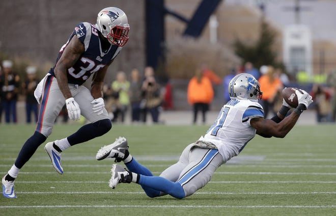 Detroit Lions wide receiver Calvin Johnson (81) catches a pass in front of New England Patriots cornerback Brandon Browner (39) in the second half of a game on Nov. 23, 2014, in Foxborough, Mass. Johnson caught 731 passes for 11,619 yards and 83 touchdowns in his career. He holds the NFL single-season receiving record with 1,964 yards. [AP Photo / Steven Senne]