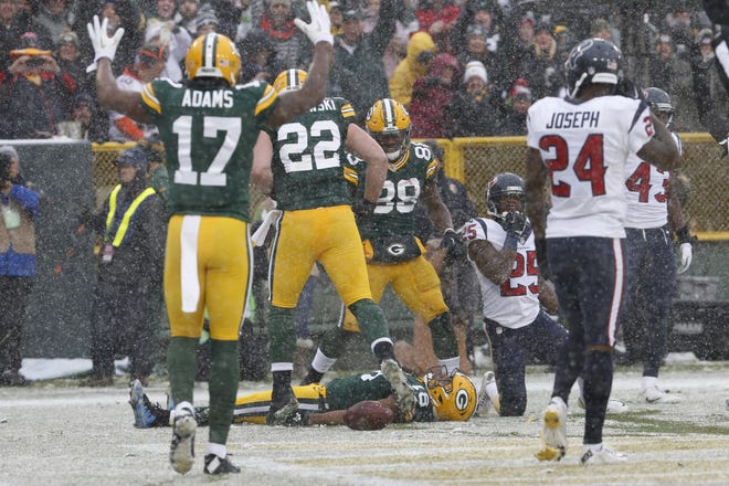 Green Bay Packers' Randall Cobb makes a snow angel after catching a touchdown pass during the first half of a game against the Houston Texans on Dec. 4, 2016,, in Green Bay, Wis. The NFL wants to put some flair back into celebrations, allowing players to use the football as a prop, celebrate as a group and roll around on the ground again if they choose. [AP Photo / Mike Roemer, File]