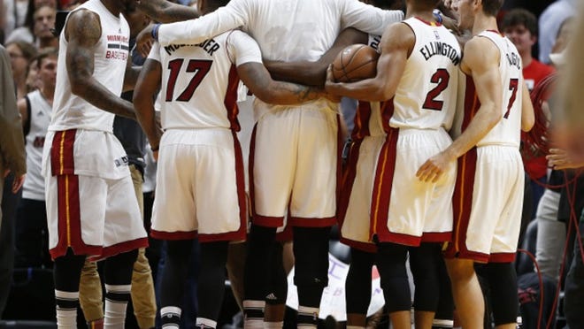 Miami Heat players celebrate after defeating the Cleveland Cavaliers 124-121 in overtime during an NBA basketball game, Monday, April 10, 2017, in Miami. (AP Photo/Wilfredo Lee)