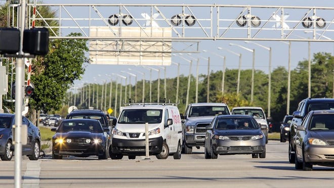 Cars head eastbound on Northlake Boulevard at the Beeline Highway during rush hour Friday morning, May 6, 2016. (Lannis Waters / The Palm Beach Post)
