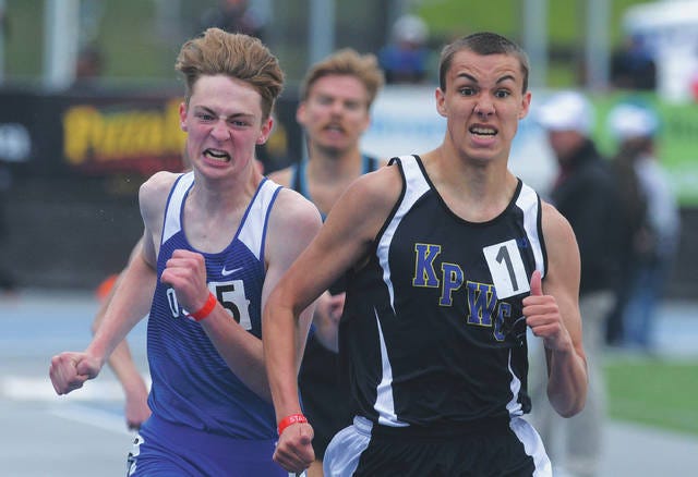 Ogden’s Andrew Stumbo nudges past KP-WC’s Eric Hoffman near the end of Saturday’s Class 2-A boys’ 1600 meters. Stumbo completed the distance double, adding to Thursday’s win in the 3,200. Photo by Nirmalendu Majumdar/Ames Tribune