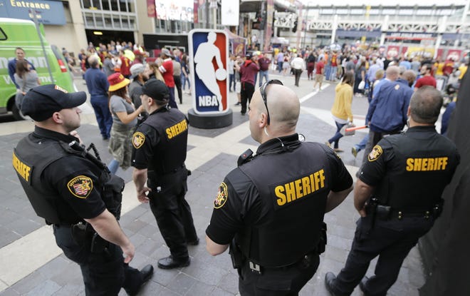 Sheriff's Deputies keep watch on fans as they enter Quicken Loans Arena for Game 4 of the NBA basketball Eastern Conference finals between the Boston Celtics and the Cleveland Cavaliers, Tuesday, May 23, 2017, in Cleveland. Security was at a heightened at the game fans after Monday's suicide bombing that killed 22 people at a Manchester, England, arena. THE ASSOCIATED PRESS
