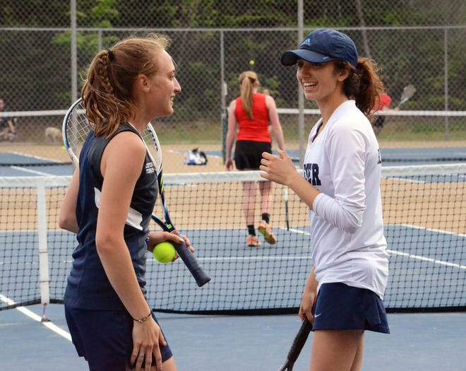 Exeter High Schoolís Melissa Wood, left, reacts with doubles partner Ashley Keaveney during Wednesdayís 6-3 playoff win over Bedford.