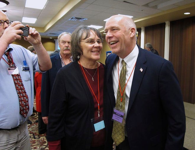 In this March 6, 2017, file photo, Greg Gianforte, right, receives congratulations from a supporter in Helena, Mont. Montana voters are heading to the polls Thursday, May 25, 2017, to decide a nationally watched congressional election amid uncertainty in Washington over President Donald Trump's agenda and his handling of the country's affairs. (AP Photo/Matt Volz, File)