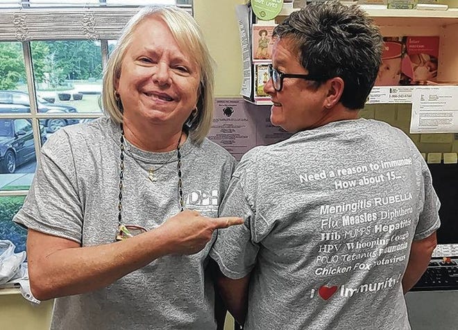 Bryan County Health Department nurses, Stephanie Keen, R.N., and Laurie Mehlhorn, R.N., showing off their “Reasons to Immunize” shirts. (Courtesy of Sally Silbermann)