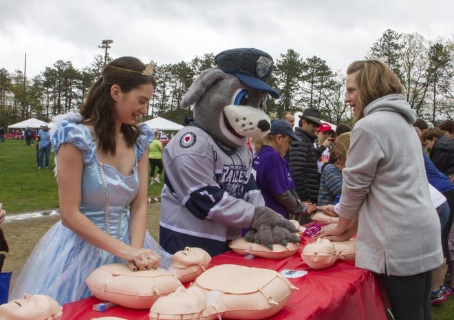 Attendees at the Heart Walk in Worcester, Massachusetts, receive training in Hands-Only CPR on May 12, 2017.