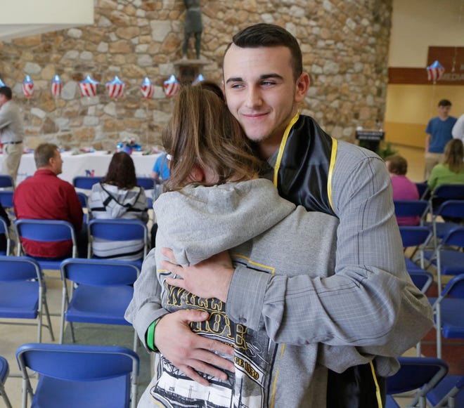 Jeremy Shuster hugs a friend before the U.S. Armed Services Commitment Ceremony at Neshaminy High School Thursday, May 25, 2017. Jeremy has enlisted in the Army.