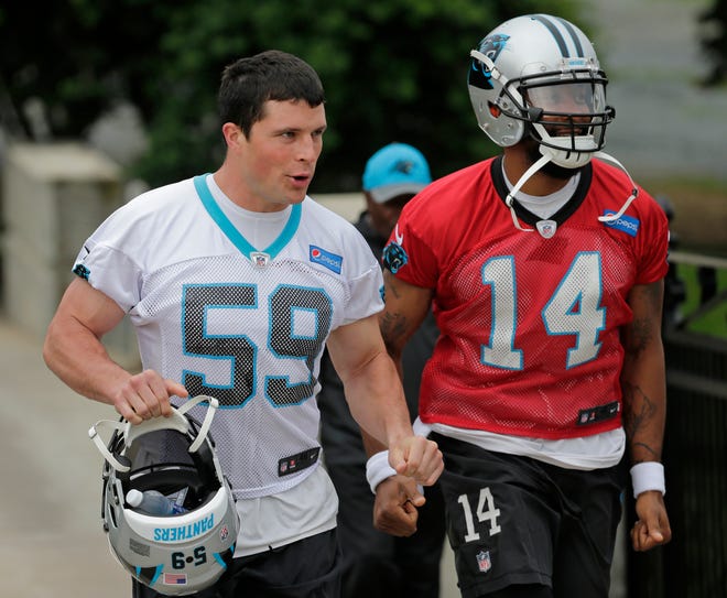 Carolina's Luke Kuechly (59) and Joe Webb jog to practice during the Panthers' organized team activity on Thursday in Charlotte, N.C. [Chuck Burton/The Associated Press]