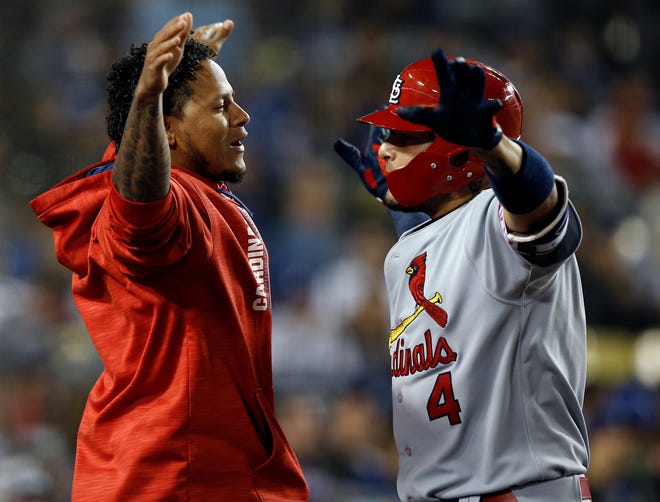 St. Louis Cardinals' Carlos Martinez, left, congratulates Yadier Molina, after Molina hit a solo home run during the seventh inning of a baseball game against the Los Angeles Dodgers in Los Angeles, Wednesday, May 24, 2017. (AP Photo/Alex Gallardo)
