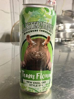 This May 15, 2017, photo provided by the Cincinnati Zoo & Botanical Garden shows a can for Listermann Brewing Company's Team Fiona beer, featuring an image of the Nile hippopotamus named Fiona born prematurely Jan. 24 at the zoo in Cincinnati. Zoo officials say the Cincinnati microbrewery's New England-style India pale ale will be introduced June 10 with 25 percent of proceeds from sales at seven Cincinnati-area stores earmarked for the zoo's #TeamFiona fundraising campaign. (Chad Yelton/Cincinnati Zoo & Botanical Garden via AP)